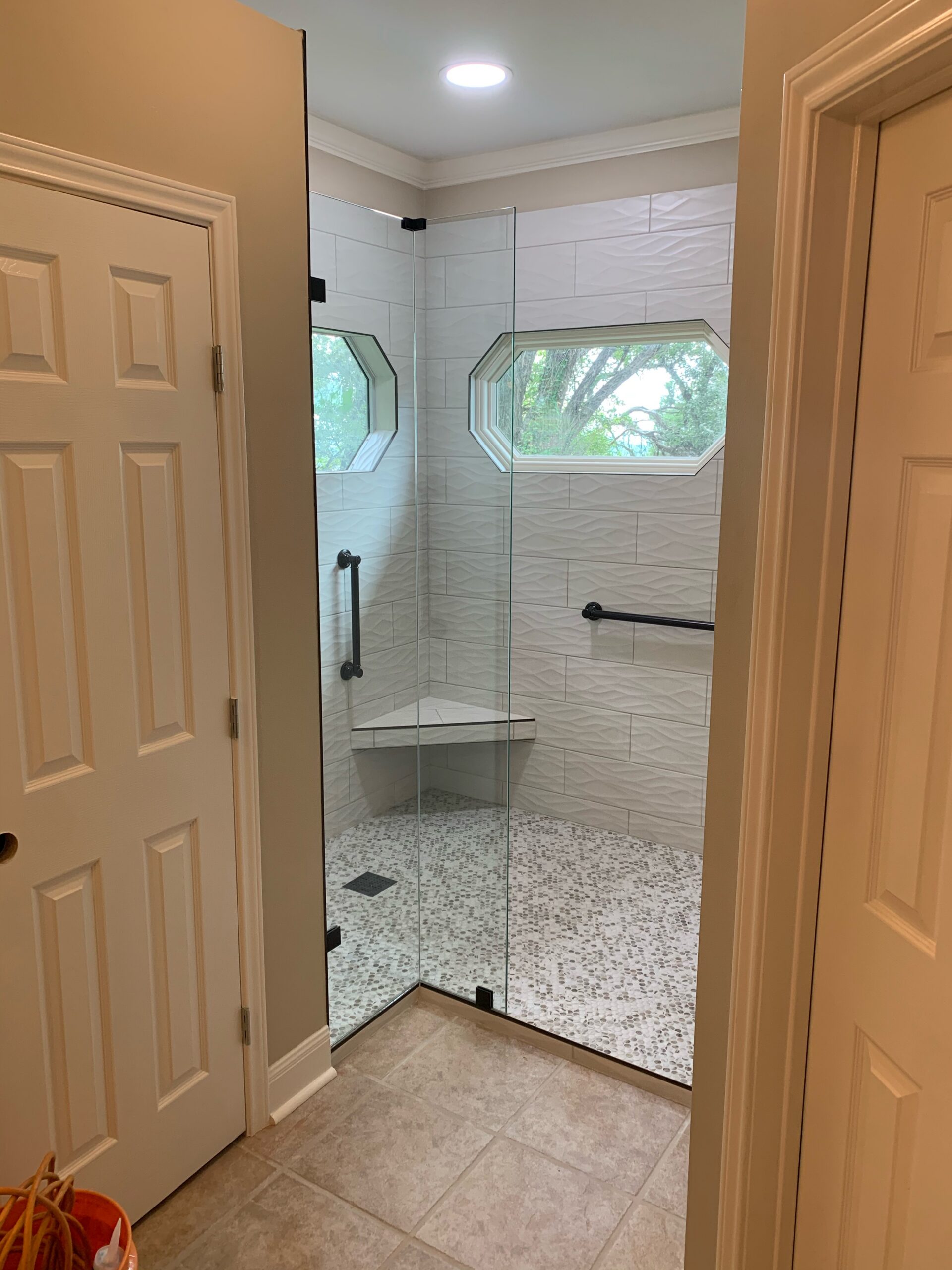 Curbless accessible shower with glass enclosure and pebble floor Austin TX