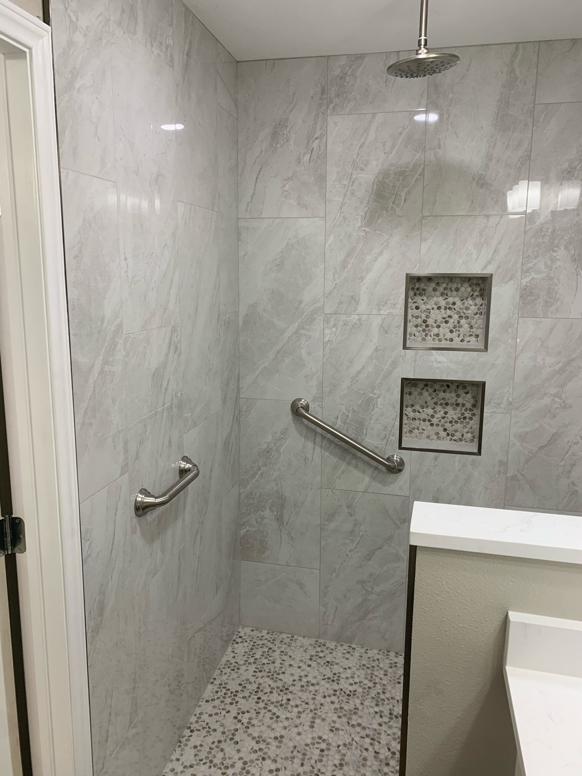 ADA grab bars and recessed niches in accessible shower remodel Austin TX